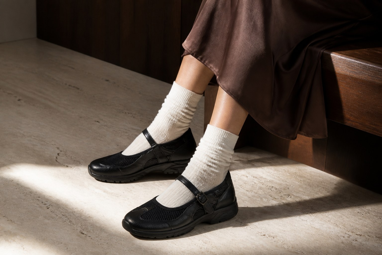 Black leather and mesh runner Mary Janes with ivory socks and a chocolate satin skirt