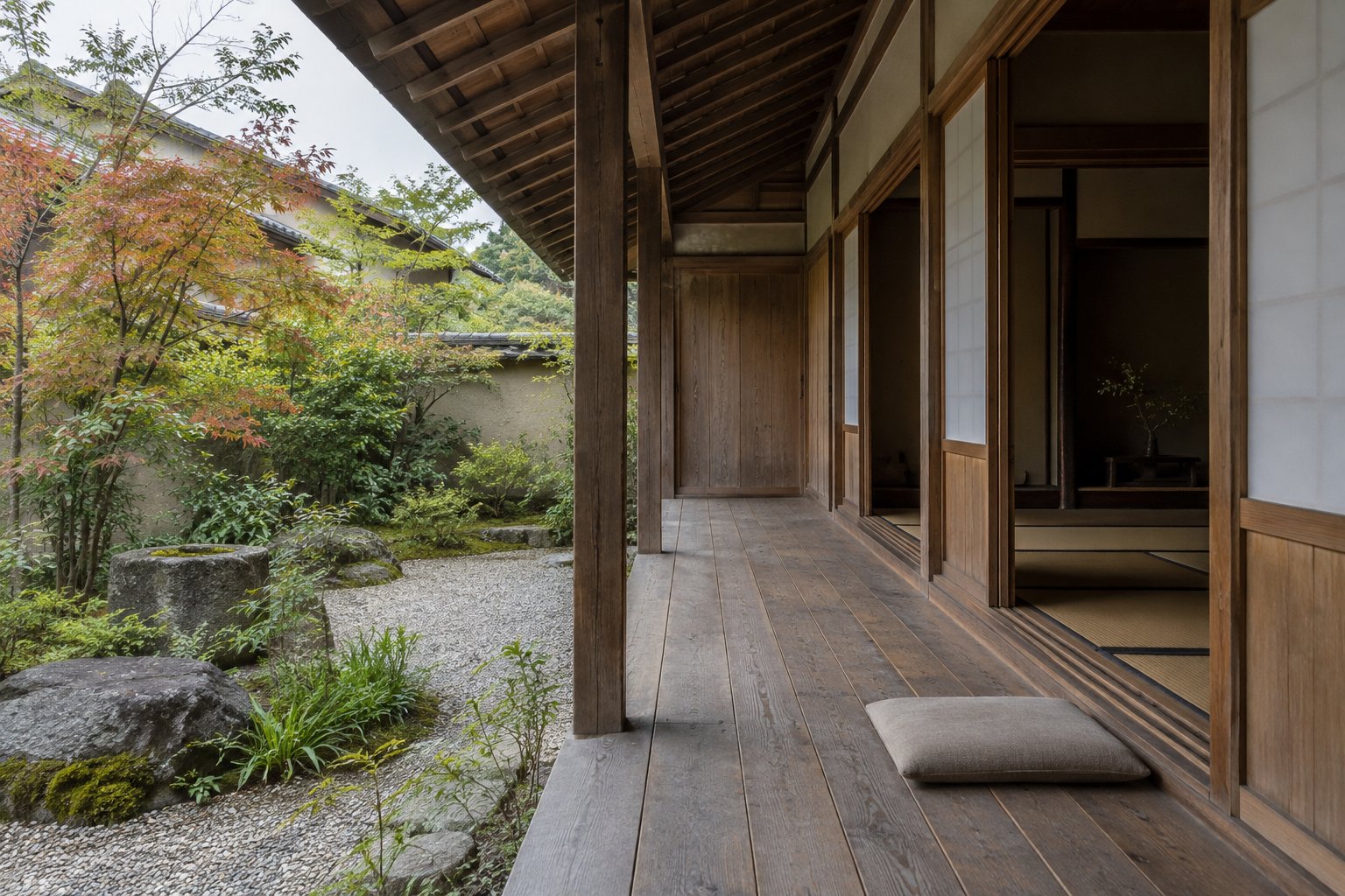 Timber engawa beneath supported roof eaves beside sliding doors and a planted Japanese-style gravel garden
