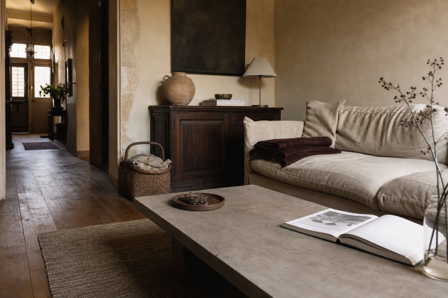 Calm lived-in living room with oak shelving, linen seating and a clear stone coffee table