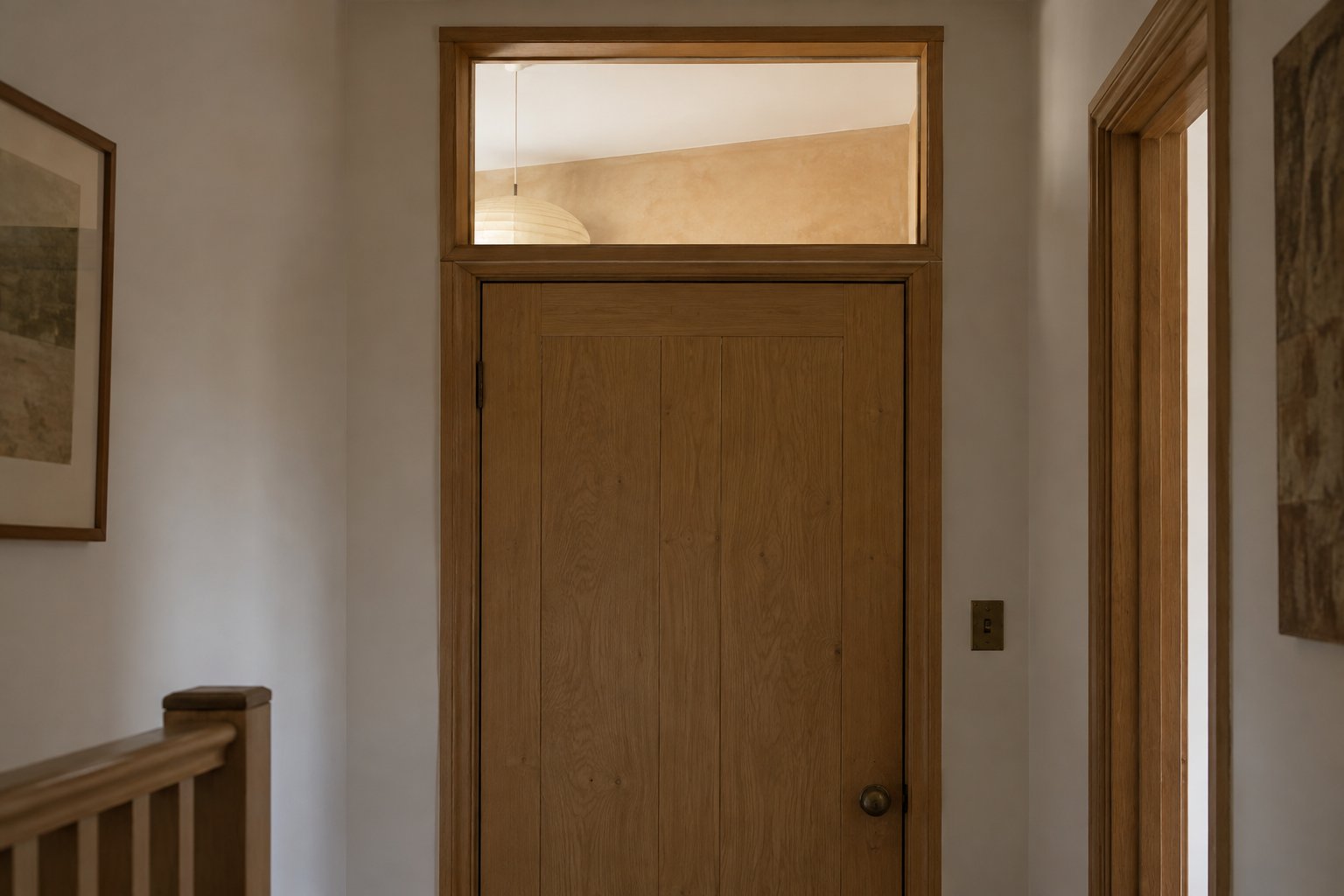 High internal transom window over a timber door in a modest entrance hallway
