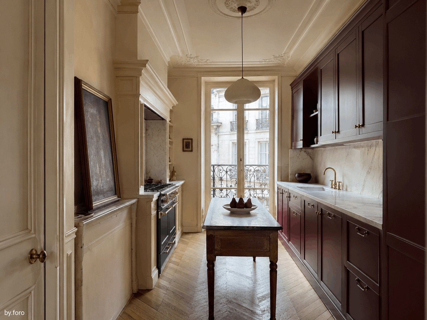 Burgundy and warm cream kitchen in a refined European townhouse