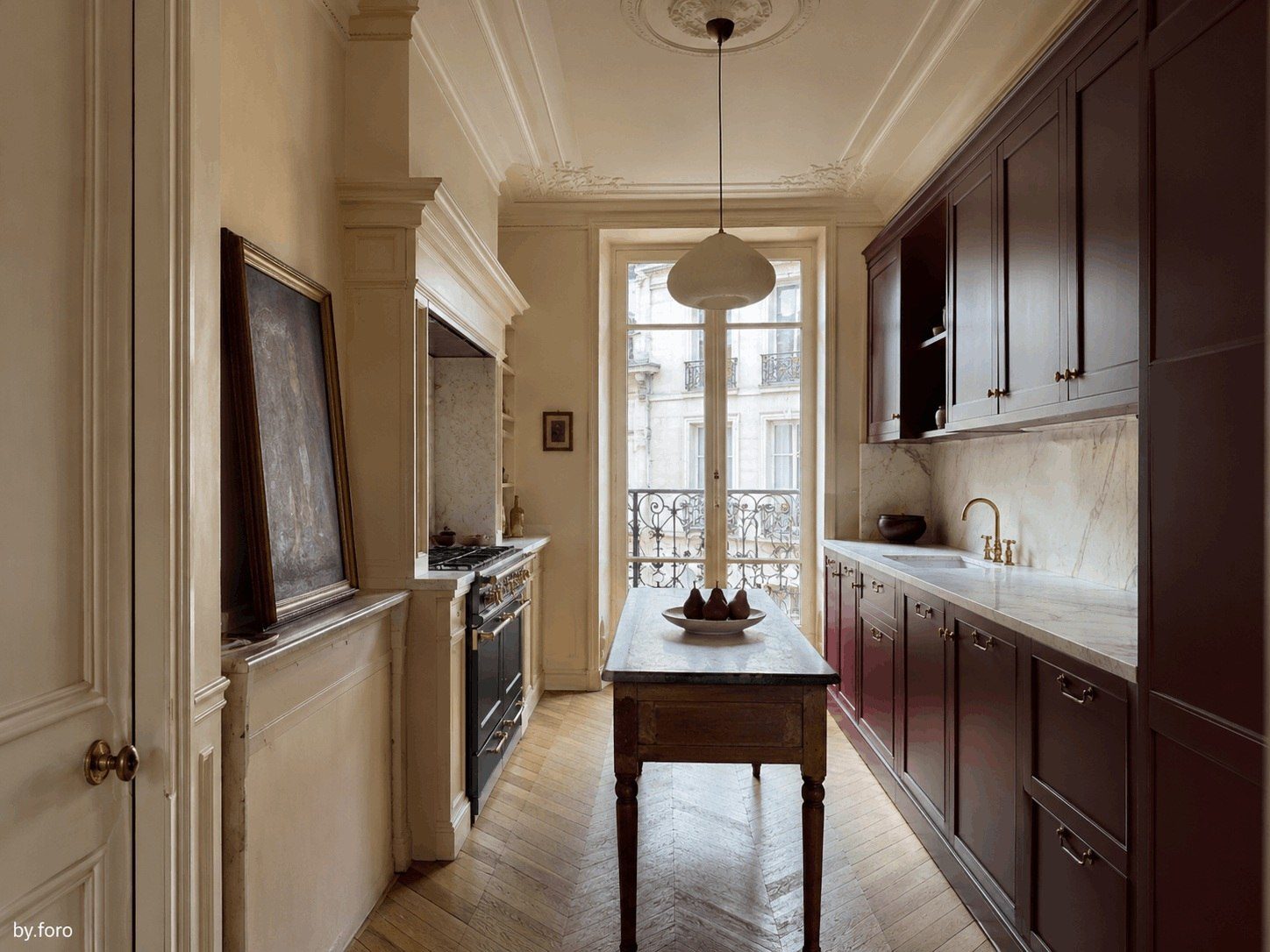 Burgundy and warm cream kitchen in a refined European townhouse