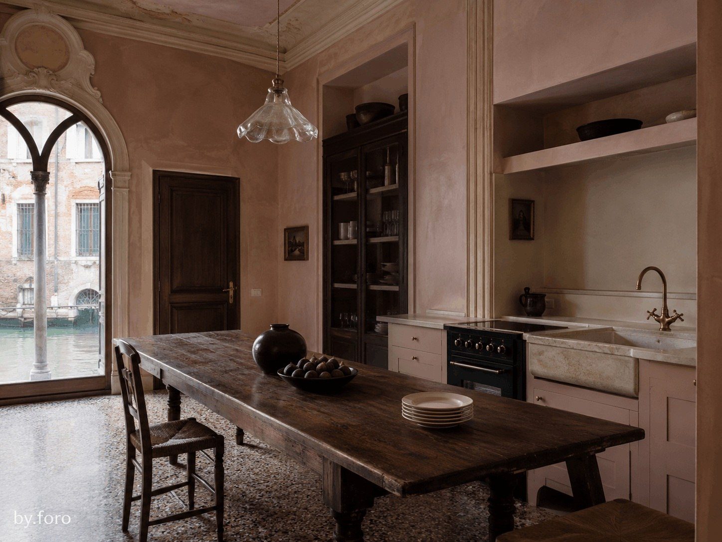 Soft pink and dark timber kitchen with Venetian architectural details