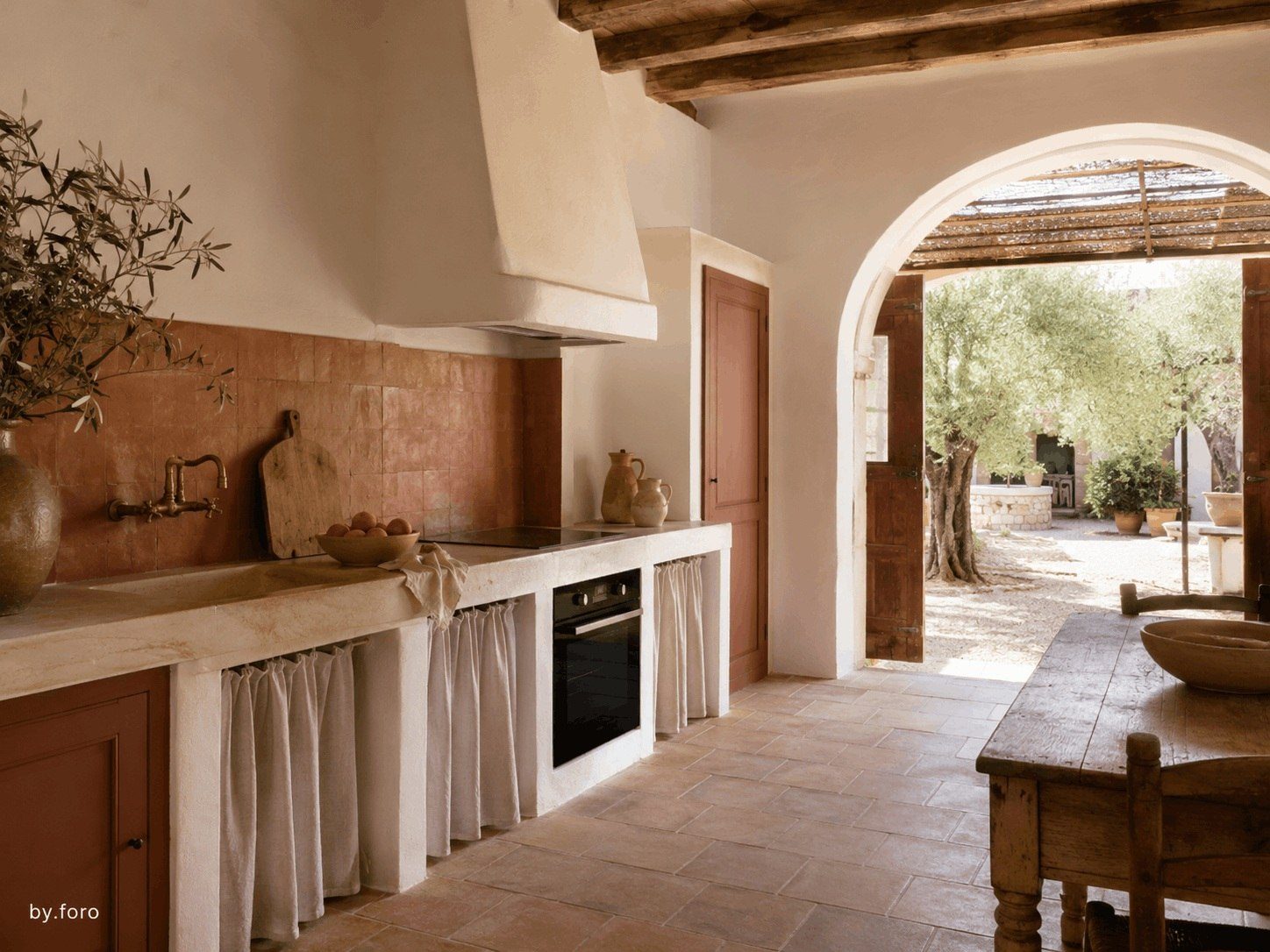 Terracotta and chalk white kitchen inside a restored Mediterranean finca